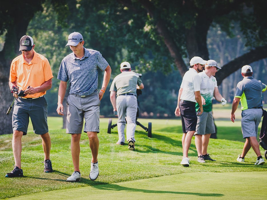 Players walking beside the green during the tournament